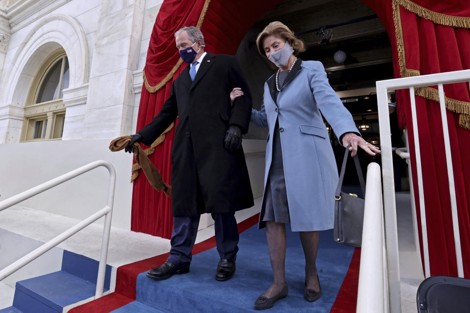 Former U.S President George W. Bush and his wife Laura Bush arrive to attend the 59th Presidential Inauguration at the U.S. Capitol in Washington, Wednesday, Jan. 20, 2021. Joe Biden was sworn in as the 46th president of the U.S. and Kamala Harris became the first woman vice president. (Jonathan Ernst/Pool Photo via AP)