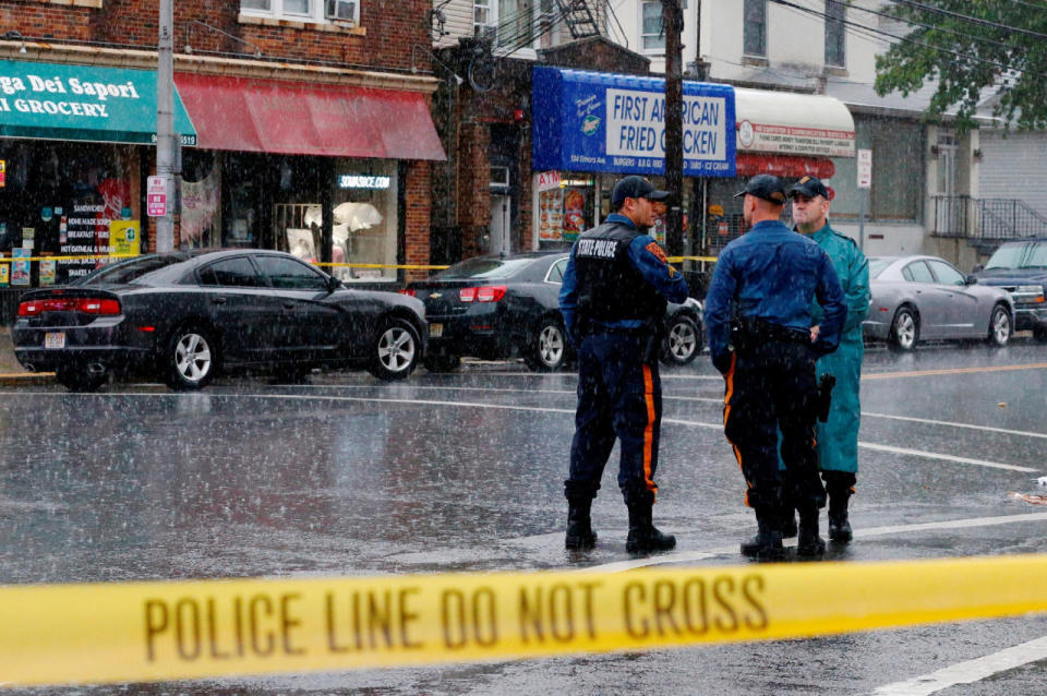 Police officers stand guard while law enforcement officers search an address during an investigation into Ahmad Khan Rahami, who was wanted for questioning in an explosion in New York, which authorities believe is linked to the explosive devices found in New Jersey, in Elizabeth. (REUTERS/Eduardo Munoz)