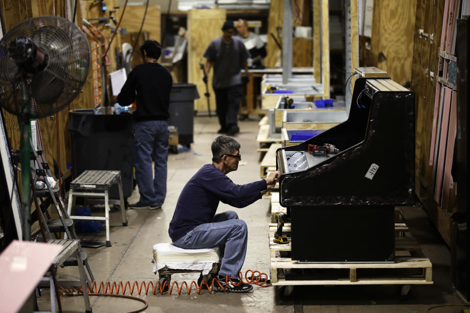 FILE - In this Oct. 18, 2018, file photo workers build refrigerators at the Howard McCray's commercial refrigeration manufacturing facility in Philadelphia. On Friday, June 14, 2019, the Federal Reserve reports on U.S. industrial production for April. (AP Photo/Matt Rourke, File)