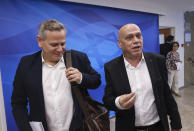 Israeli Minister of Health Nitzan Horowitz, left, and Minister of Regional Cooperation Issawi Frej arrive for the first weekly cabinet meeting of the new government in Jerusalem, Sunday, June 20, 2021. Prime Minister Naftali Bennett opened his first Cabinet meeting on Sunday since swearing in his new coalition government with a condemnation of the newly elected Iranian president, whom he called “the hangman of Tehran.” (Emmanuel Dunand/Pool Photo via AP)