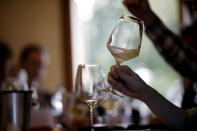 In this image taken on Monday, Oct. 15, 2018, an expert wine tester shakes a glass of Prosecco during a wine testing at the Case Paolin farm, in Volpago del Montello, Italy. Prosecco has become the best-selling sparkling wine in the world, and experts say it is eroding the more casual corner of champagne's market while aiming higher. Its production eclipsed champagne's five years ago and is now 75 percent higher at 544,000 bottles three-quarters of which for export.0 bottles three-quarters of which for export.(AP Photo/Luca Bruno)