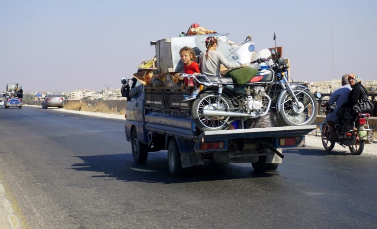 Syrian children squeeze in among family belongings in the back of a pick-up on September 11, 2018 as they flee an anticipated government offensive on Idlib