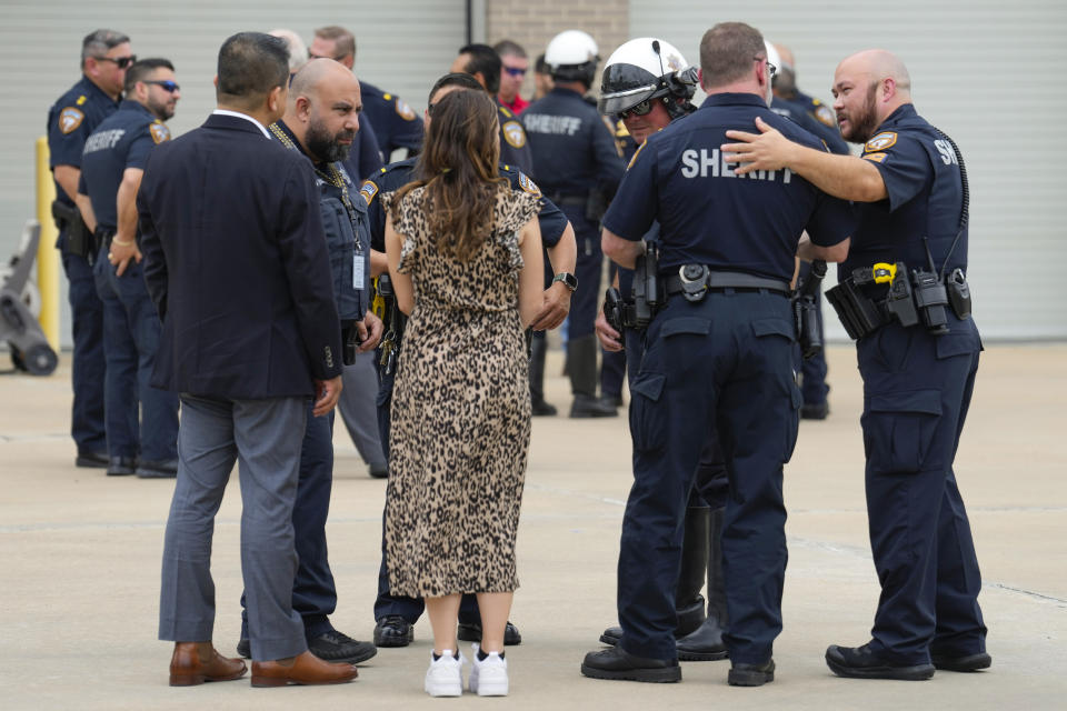 Sheriff's deputies comfort each other as they gather outside Harris County Institute of Forensic Sciences as they pay respect to Deputy John Hampton Coddou Tuesday, April 23, 2024, in Houston. Coddou was struck by a vehicle while responding to a crash on Highway 99 and Cumberland Ridge Drive in Cypress, Texas. The deputy was transported by Life Flight in critical condition to Memorial Hermann where he later died. (Brett Coomer/Houston Chronicle via AP)