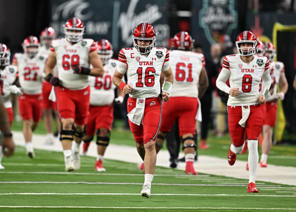 Utah Utes quarterback Bryson Barnes (16) and other players run onto the field as Utah and Northwestern prepare to play in the SRS Distribution Las Vegas Bowl on Saturday, Dec. 23, 2023. | Scott G Winterton, Deseret News