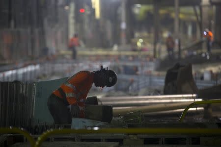 A sandhog works in a tunnel in the East Side Access project, more than 15 stories beneath Midtown Manhattan where workers are building a new terminal for the Long Island Railroad, the United States' busiest commuter rail system, is seen during a media tour of the site in New York, November 4, 2015. REUTERS/Mike Segar