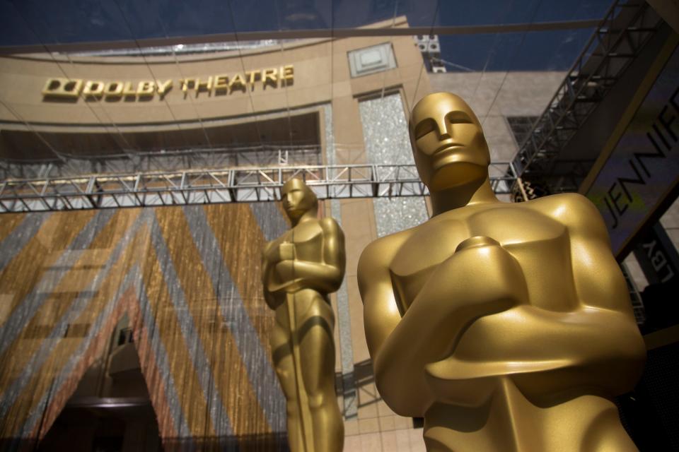 Giant Oscar statues stand near the entrance to the Dolby Theatre on the red carpet during setup for the 88th annual Academy Awards at the Dolby Theatre. 