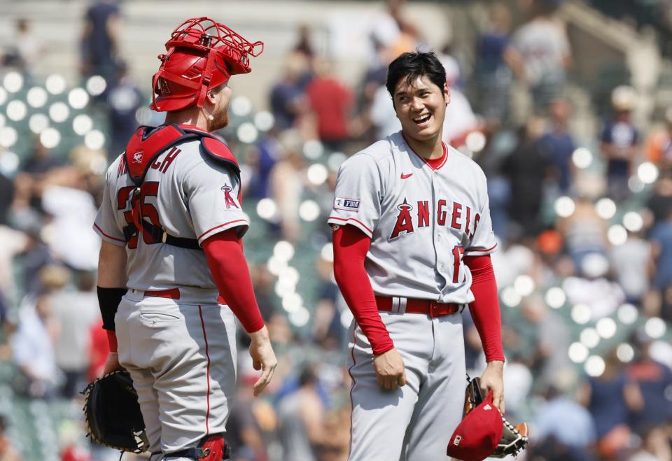 Shohei Ohtani of the Los Angeles Angels laughs with catcher Chad Wallach #35 after pitching a complete game shutout against the Detroit Tigers in game one of a doubleheader at Comerica Park on July 27, 2023 in Detroit, Michigan. The Angels won 6-0.