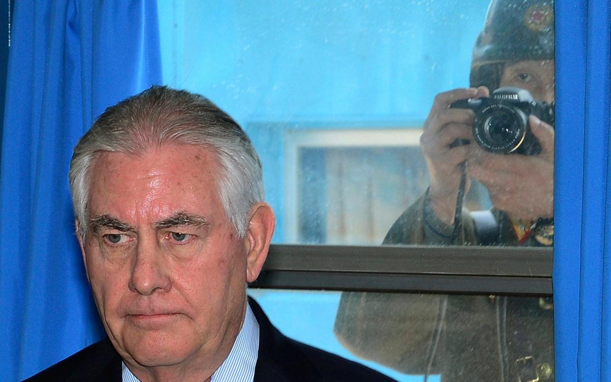 A North Korean soldier takes a picture of Rex Tillerson when he visited Panmunjom, the truce village near the inter-Korean border, on Friday - Korea Pool/Yonhap