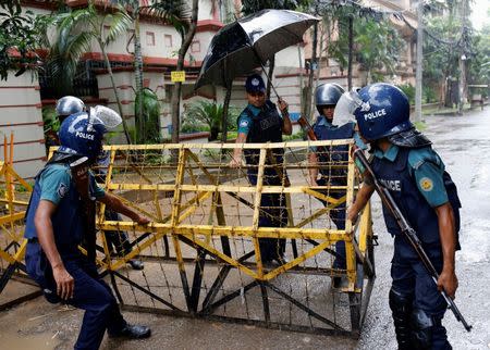 Policemen move a barricade on the road leading to the Holey Artisan Bakery and the O'Kitchen Restaurant after gunmen attacked, in Dhaka, Bangladesh, July 3, 2016. REUTERS/Mohammad Ponir Hossain