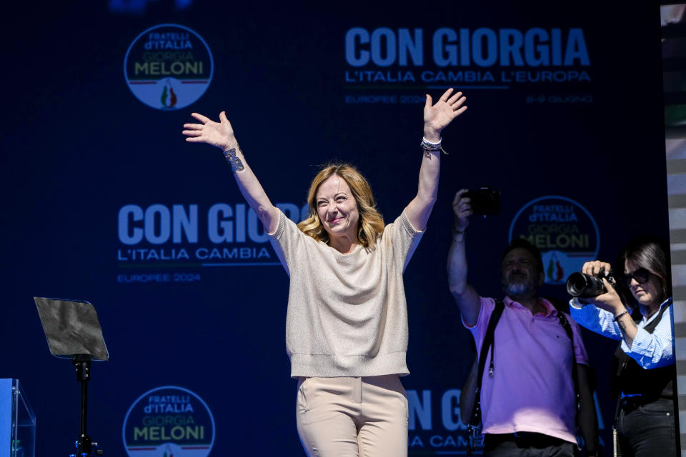 Italian Premier Giorgia Meloni waves from the stage during an electoral rally ahead of the EU parliamentary elections that will take place in Italy on 8 and 9 June, in Rome, Saturday, June 1, 2024. (AP Photo/Alessandra Tarantino)