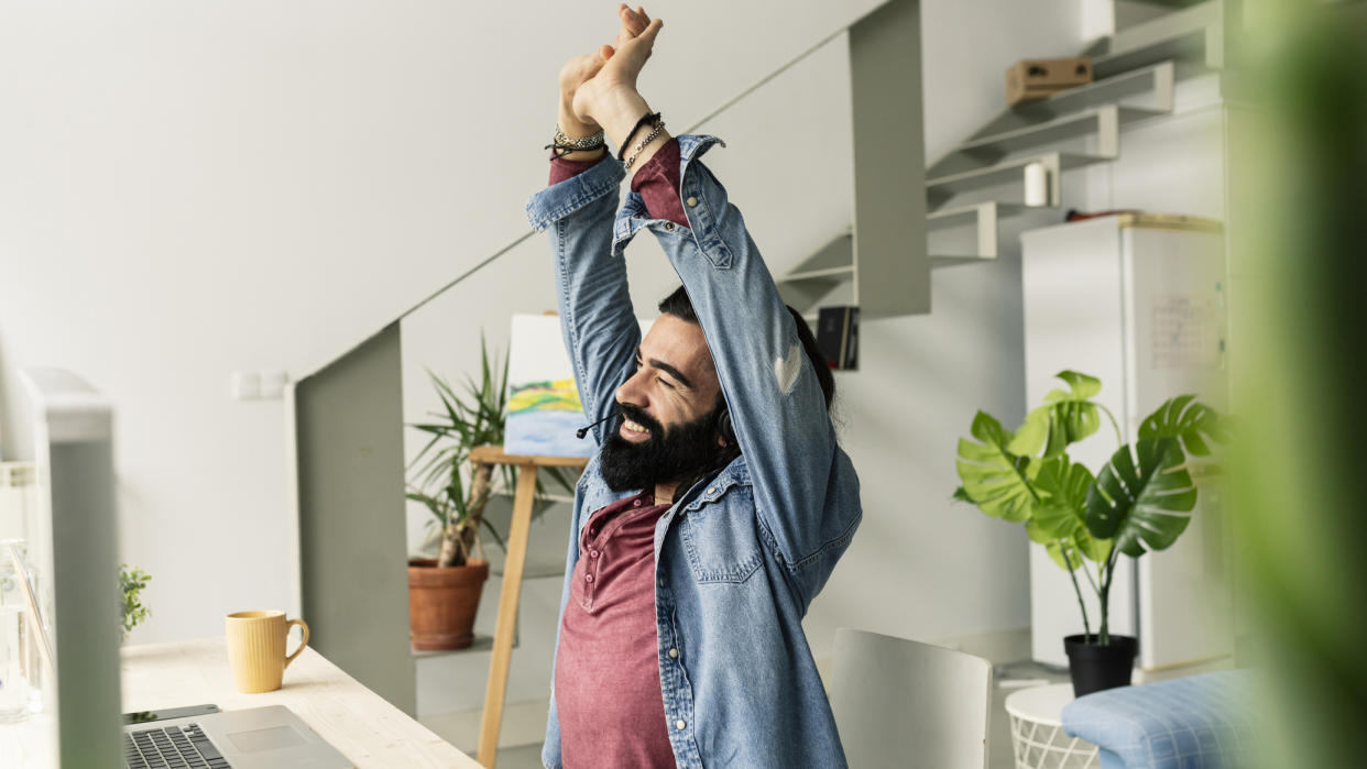  Man stretching in office chair. 