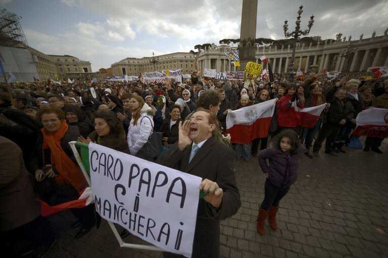 A man cheers holding a banner reading "Dear Pope we will miss you" during Pope Benedict XVI's last Angelus Prayer in St. Peter's Square at Vatican on February 24, 2013. Tens of thousands of supporters turned out, often interrupting him with clapping, cheering and chanting