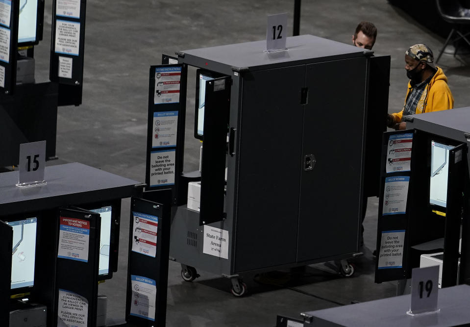 Gary Ragland, 64, of East Point, Ga., votes at State Farm Arena on Wednesday, Oct. 28, 2020, in Atlanta. In the best of times, it’s a massive logistical challenge to get millions out to vote. In 2020, the difficulty has been dramatically compounded: by fear of the coronavirus, by complications and confusion over mail-in ballots, by palpable anxiety over the bitter divisions in the country. (AP Photo/Brynn Anderson)