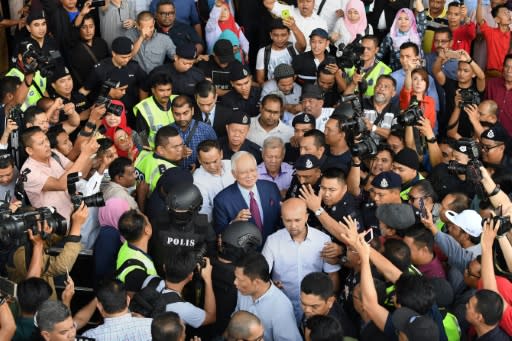 Former Malaysian prime minister Najib Razak (C) says the trial is 'the best way to clear my name'