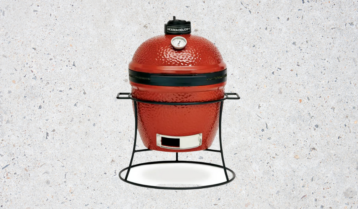 A red and black-trimmed egg-style charcoal grill