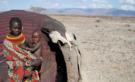 A Turkana tribeswoman holds her child in a village near Loiyangalani, Kenya, March 20, 2017. REUTERS/Goran Tomasevic/Files