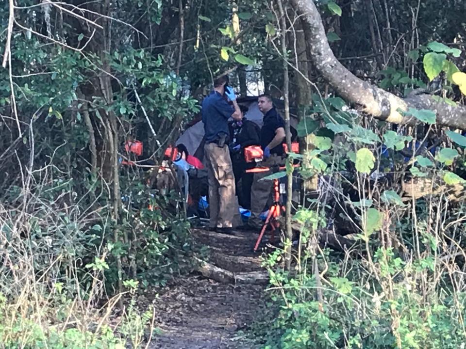 Ocala Police Department detectives outside the tent where Roland Henry Lanctot's body was discovered.