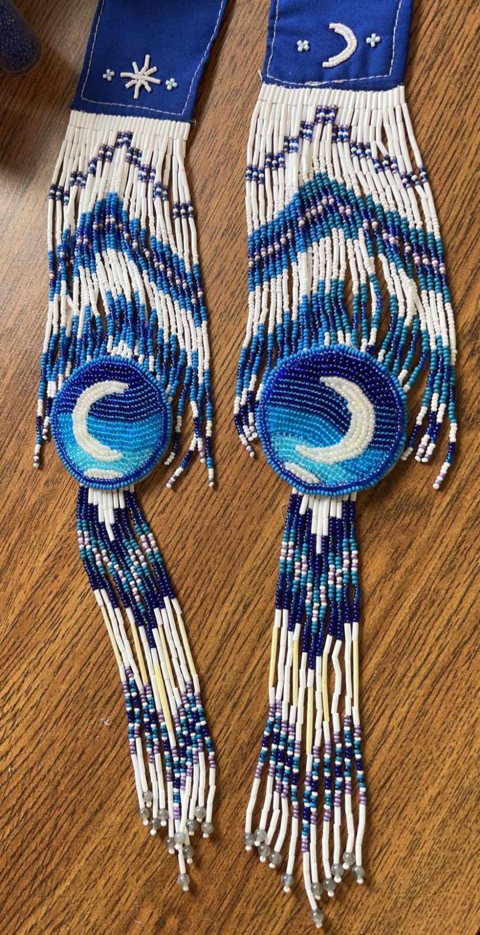 Haley Edmunds-Shiwak was given colours and guidelines that she could use to create her design for Avatar: The Last Airbender. She decided to create a scarf with beaded moon medallions. 