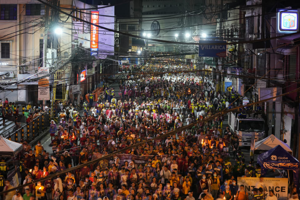 Devotees participate in the "Walk of Faith" procession as part of celebrations for the feast day of the Black Nazarene, a centuries-old charred statue of Jesus Christ, on Sunday, Jan. 8, 2023, in Manila, Philippines. The Black Nazarene draws massive numbers of largely poor devotees who pray for the sick and a better life in this predominantly Roman Catholic nation. (AP Photo/Aaron Favila)