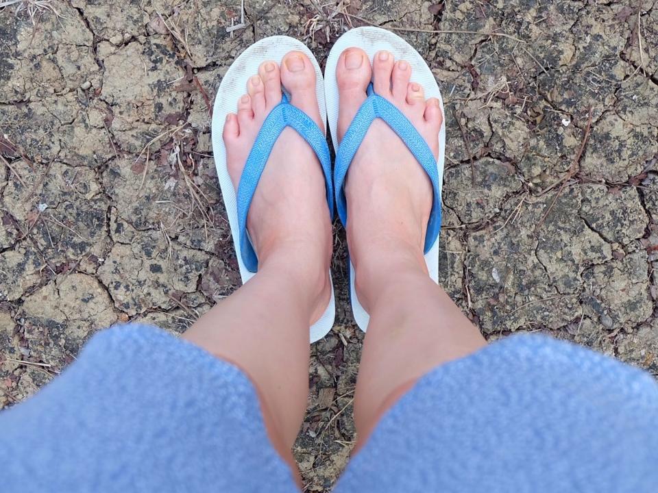 shot of someone's feet wearing flipflops outside