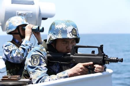 Chinese soldiers take part in Joint Sea-2014 naval exercise outside Shanghai on the East China Sea, May 23, 2014. REUTERS/China Daily