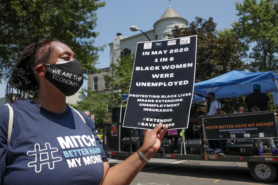 Angela Moore joins protesters as they temporarily block the street to U.S. Senate Majority Leader Mitch McConnell's (R-KY) house with a live band on a flatbed truck, demanding the extension of coronavirus disease (COVID-19)-related unemployment aid, on Capitol Hill in Washington, U.S. July 22, 2020. REUTERS/Jonathan Ernst