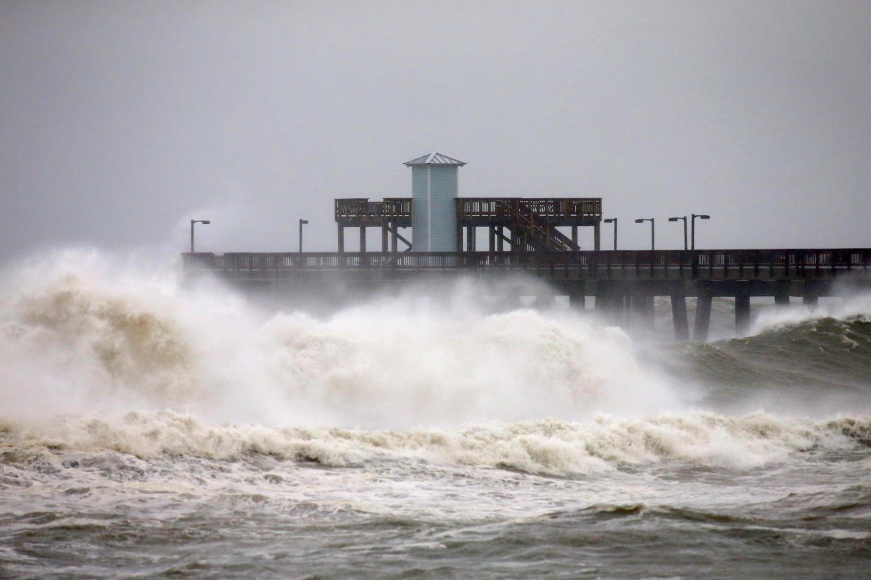 Waves crash along a pier as Hurricane Sally approaches in Gulf Shores, Alabama, U.S., September 15, 2020.  REUTERS/Jonathan Bachman