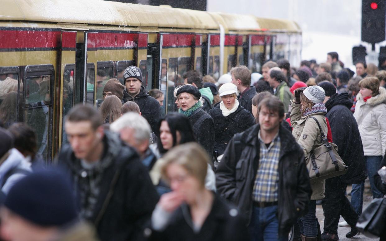 Commuters board a train in Berlin - Getty Images