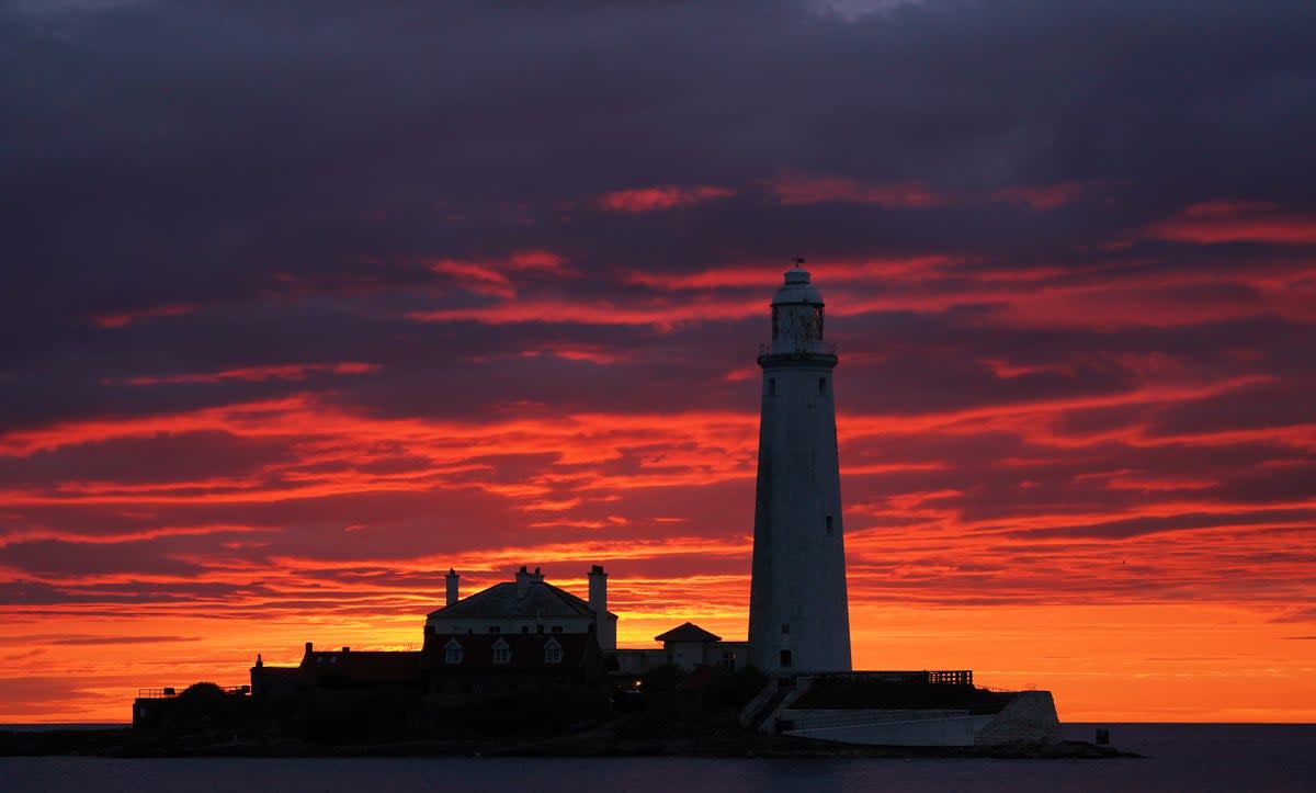 A fire coloured sky above St Mary’s Lighthouse in Whitley Bay (PA) (PA Wire)