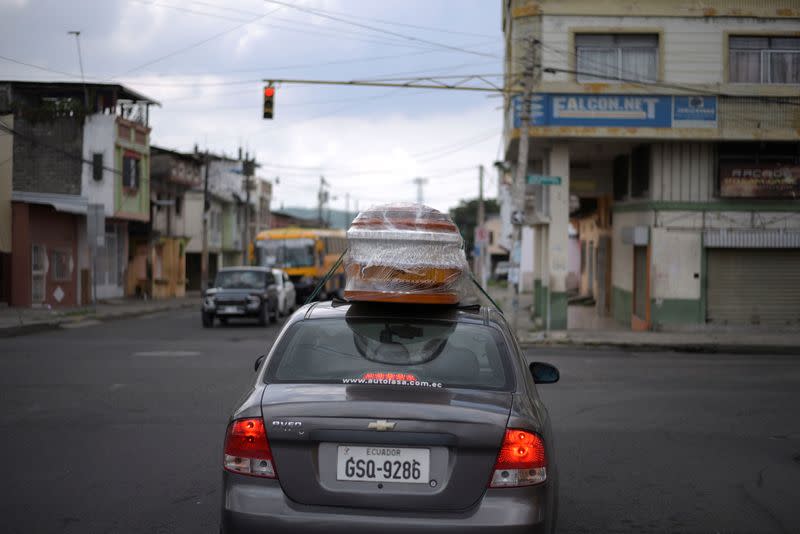 A couple transports an empty coffin to collect the body of a relative as Ecuador's government announced on Thursday it was building a "special camp" in Guayaquil for coronavirus disease (COVID-19) victims, in Guayaquil