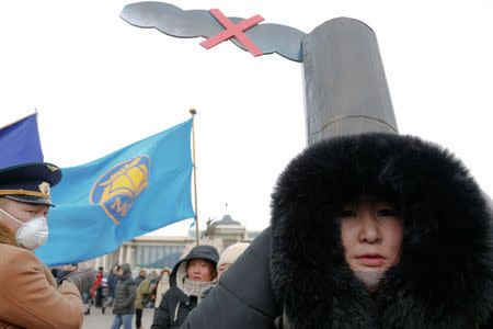 A woman wears a costume as she takes part in an anti-pollution protest in front of a government building in central Ulaanbaatar, Mongolia January 28, 2017. REUTERS/B. Rentsendorj