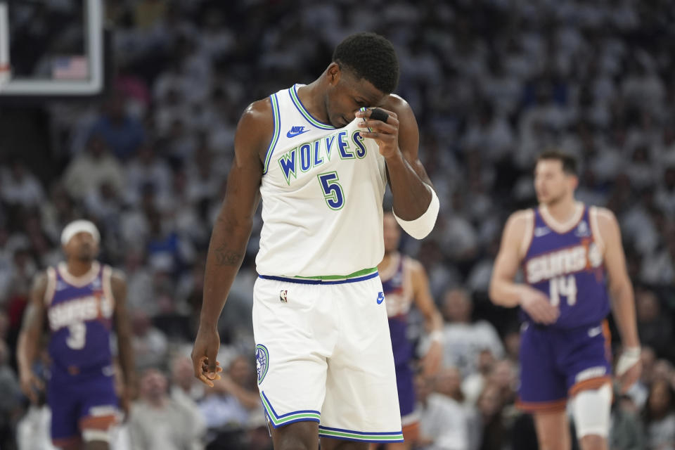 Minnesota Timberwolves guard Anthony Edwards (5) walks on the court during the first half of Game 2 of the team's NBA basketball first-round playoff series against the Phoenix Suns, Tuesday, April 23, 2024, in Minneapolis. (AP Photo/Abbie Parr)