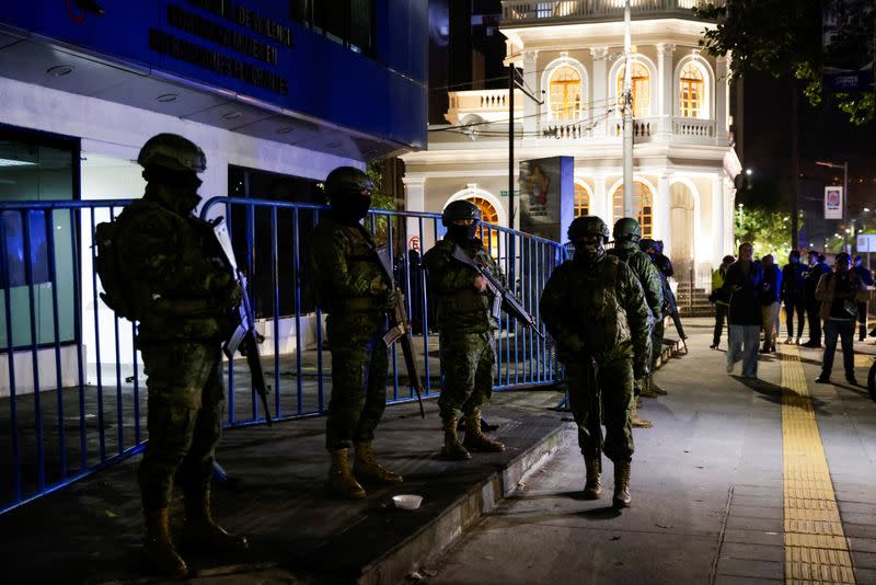 Police and military officials stand outside the Flagrancy Unit, where former Ecuador Vice President Jorge Glas is believed to be detained, in Quito