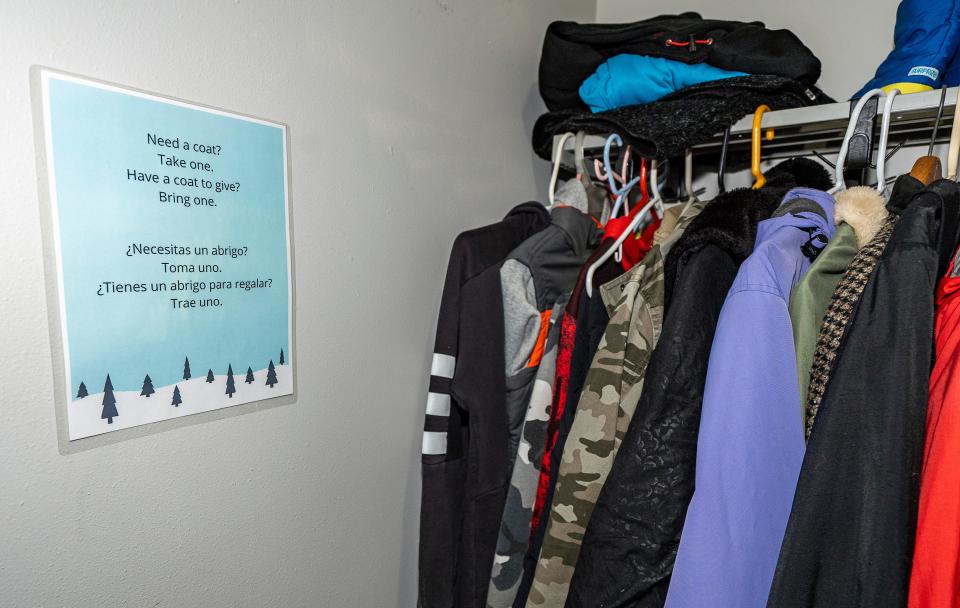A free coat closet, alongside a bilingual sign, is available to anyone in need at Irvin L. Young Memorial Library. A stack of warm blankets went quickly as the weather turned colder recently, said Diane Jaroch, interim library director.