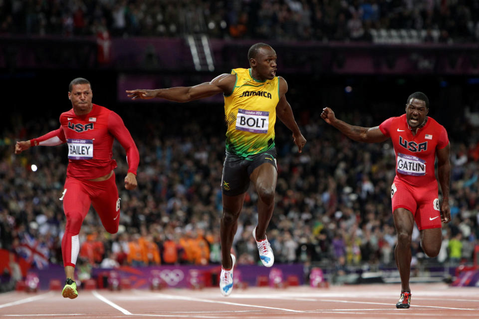 LONDON, ENGLAND - AUGUST 05: Usain Bolt of Jamaica crosses the finish line ahead of Ryan Bailey of the United States and Justin Gatlin of the United States to win the Men's 100m Final on Day 9 of the London 2012 Olympic Games at the Olympic Stadium on August 5, 2012 in London, England. (Photo by Michael Steele/Getty Images)