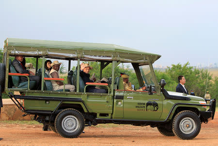 FILE PHOTO: Chinese Premier Li Keqiang (front, 3rd L), who is on an official state visit, waves from a tour van shortly before driving out for a game drive at the Nairobi National Park in Kenya, May 10, 2014. REUTERS/Noor Khamis/File Photo