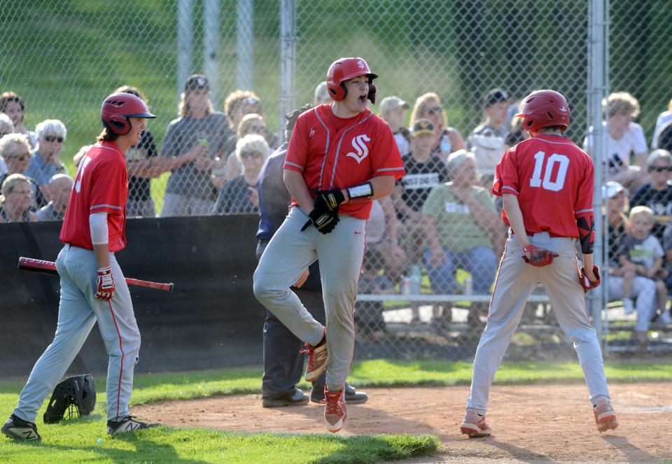 Sheridan sophomore Caden Sheridan celebrates with Austin Clifton, left, and Blaine Hannan after scoring the go-ahead run during the fifth inning of a 7-2 win against host Tri-Valley on May 12, 2022, at Kenny Wolford Park in Dresden. Caden Sheridan returns as the Muskingum Valley League's Big School Division Player of the Year after driving in 30 runs in 2022.