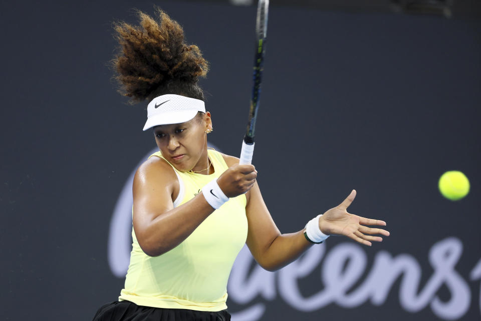 Naomi Osaka of Japan plays a shot in her match against Tamara Korpatsch of Germany during the Brisbane International tennis tournament in Brisbane, Australia, Monday, Jan. 1, 2024. (AP Photo/Tertius Pickard)