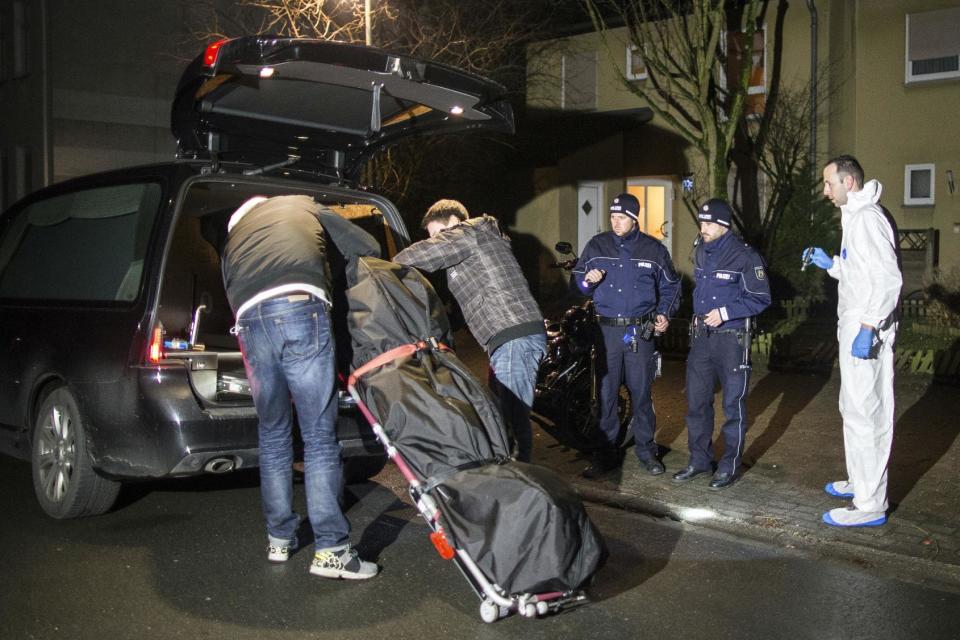 Undertakers lift a stretcher with a bodybag into a hearse in Herne, Germany, Tuesday, March 7, 2017. German police said Tuesday they have launched a manhunt for a 19-year-old man who allegedly killed a 9-year-old boy in the western town of Herne and boasted about the murder on a video posted online. (Marcel Kusch/dpa via AP)