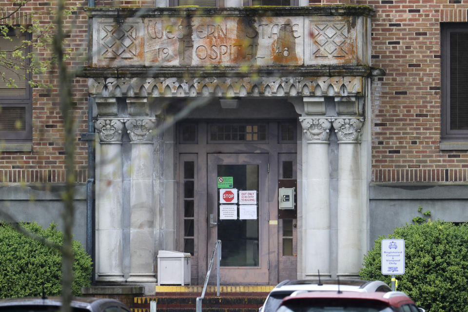 In this April 22, 2020, photo, signs on an entrance to a building at Western State Hospital in Lakewood, Wash., tell employees that they must be medically screened at one of two other buildings before entering. Employees at the facility — the state's largest psychiatric hospital — say that problems with testing for the coronavirus likely produced inaccurate results and exposed them to the virus a second time. (AP Photo/Ted S. Warren)