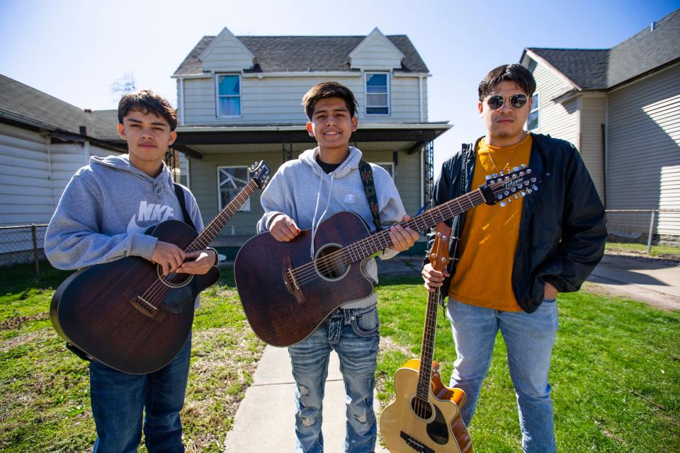 Members of the group Los de San Rafael, from left, Moises Ruelas, Isac Ruelas and Gabriel Saenz, pose for a portrait Thursday, April 21, 2022, on the west side of South Bend.