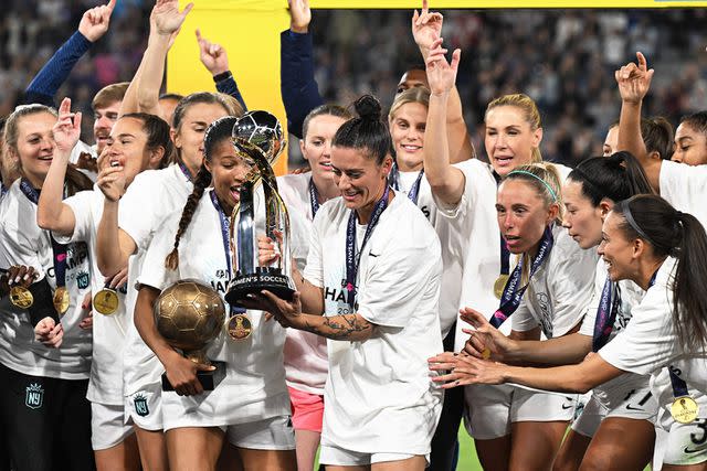 <p>Robyn Beck/AFP via Getty</p> Gotham FC's US defender #11 Ali Krieger holds the Championship trophy after Gotham FC won the National Women's Soccer League final match against OL Reign at Snapdragon Stadium in San Diego, California, on November 11, 2023.