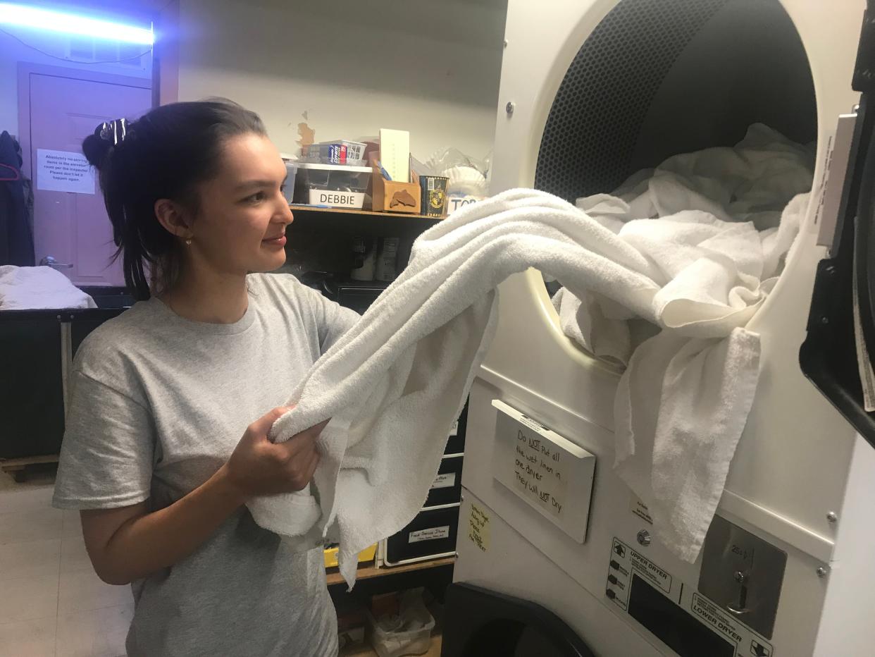 Karina, a 20 year-old student from Kazakhstan, takes laundry out of a dryer at Our Guest Inns & Suites in Port Clinton. She is a J-1 VIsa Exchange student that will work in Ottawa County for four months. The county's hospitality industry relies on J-1 students to help shore up its labor pool during the busy summer tourism season.