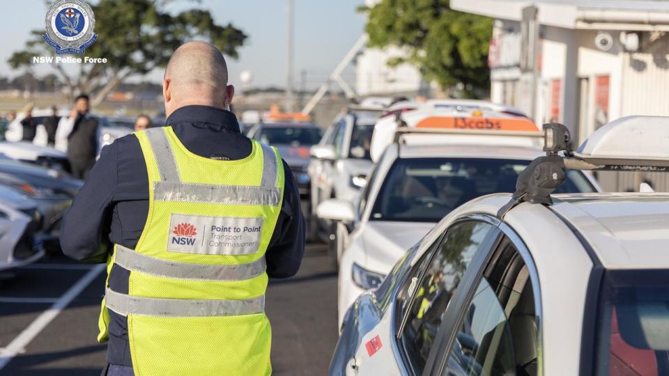 Officials check e-tags at Sydney Airport.