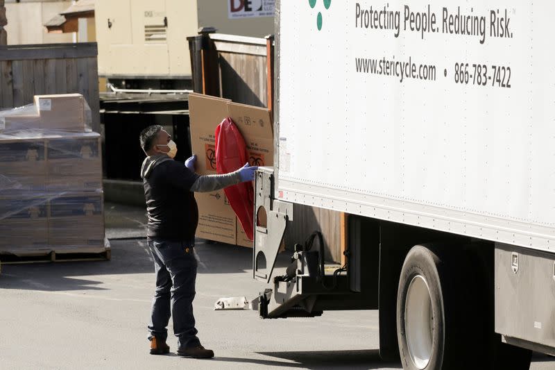 A worker unloads a delivery at the Life Care Center of Kirkland, the long-term care facility linked to several confirmed coronavirus cases in the state, in Kirkland