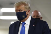 President Donald Trump wears a face mask as he walks down a hallway during a visit to Walter Reed National Military Medical Center in Bethesda, Md., Saturday, July 11, 2020. (AP Photo/Patrick Semansky)