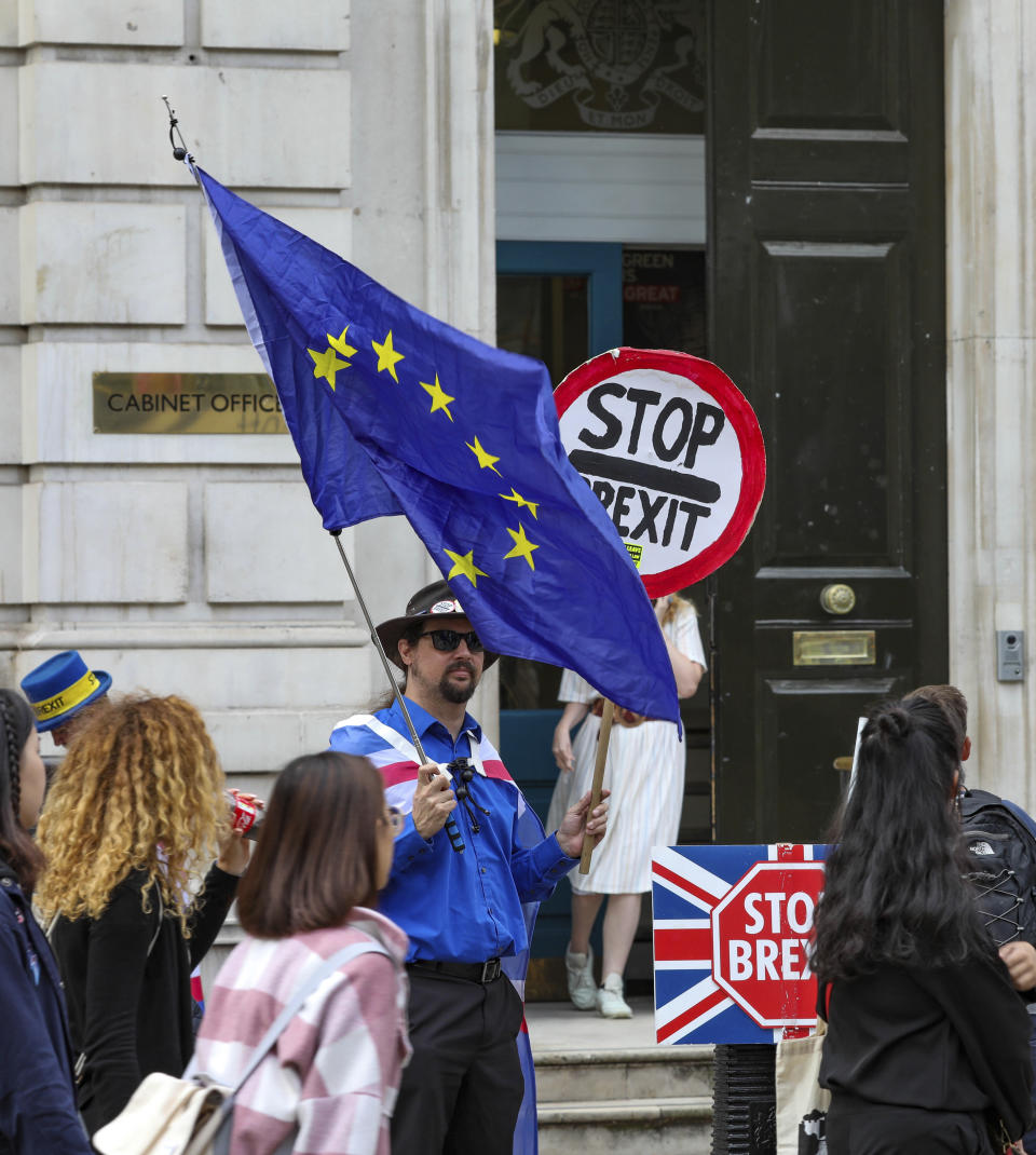 Anti-Brexit protesters demonstrate outside the Cabinet Office in Whitehall in London on Thursday, Aug. 15, 2019. Demonstrations for both sides of the Brexit debate continue around parliament, as Prime Minister Boris Johnson has vowed that Britain will leave the EU on Oct. 31, with or without a Brexit deal. (AP Photo/ Vudi Xhymshiti)