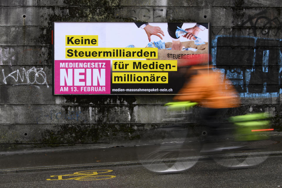 A poster reading 'No tax billions for media millionaires. Media Law No' displayed on a wall in Bern, Switzerland, Wednesday, Feb. 2022. On Sunday, Feb. 13, 2022, voters in Switzerland consider on a government's public aid plan to support broadcast and print media. (Anthony Anex/Keystone via AP)