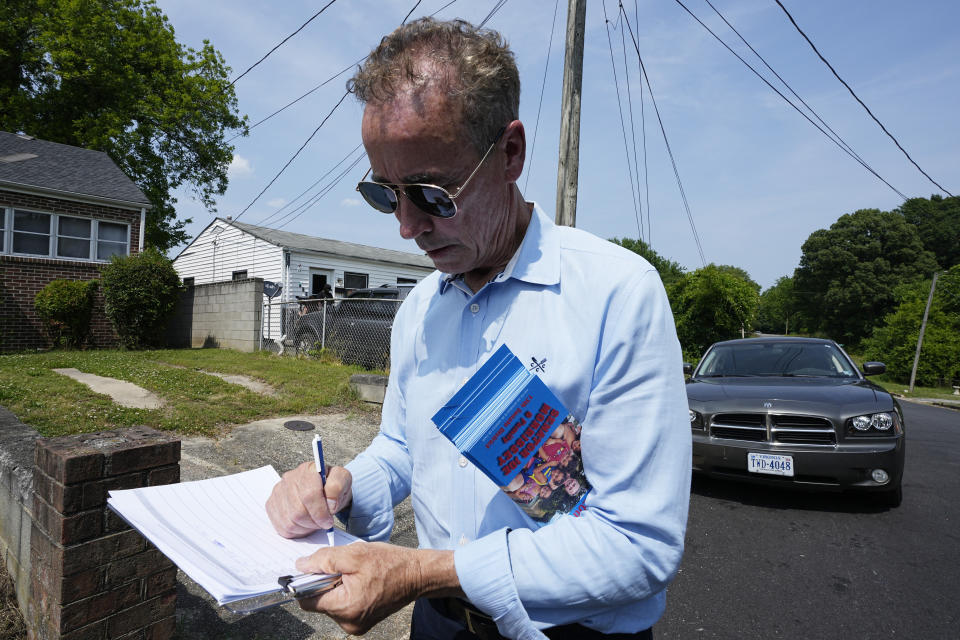 Virginia state Sen. Joe Morrissey takes notes as he canvasses a neighborhood, Monday, May 22, 2023, in Petersburg, Va. Morrissey is being challenged in a Democratic primary for a newly redrawn senatorial district by former Delegate Lashrecse Aird. (AP Photo/Steve Helber)