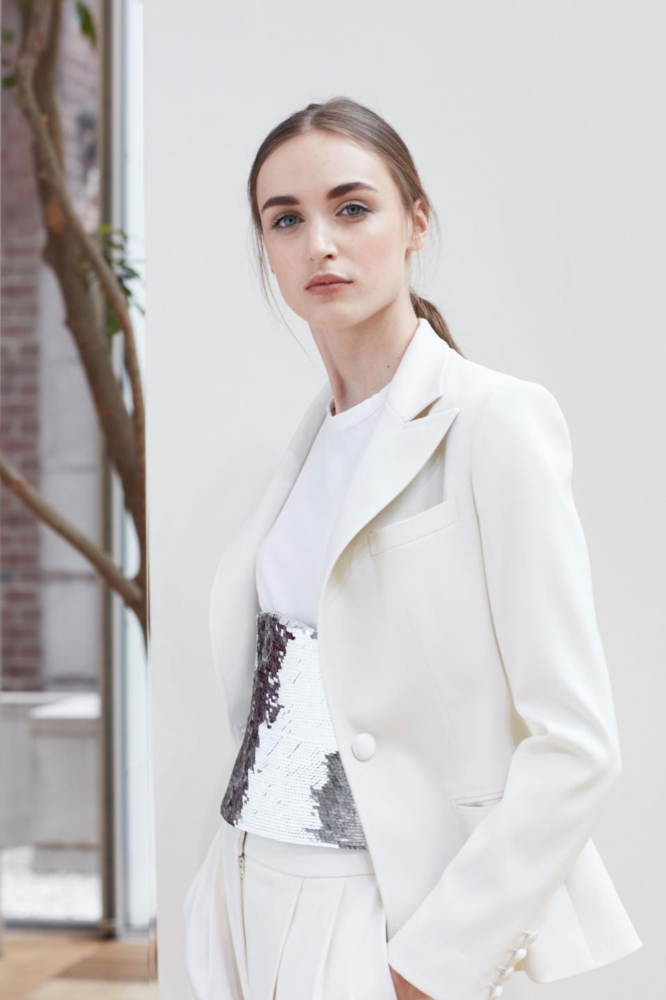 Ivory suit, cotton T-shirt, and silver-sequin corset from the Oscar de la Renta Spring 2018 bridal collection